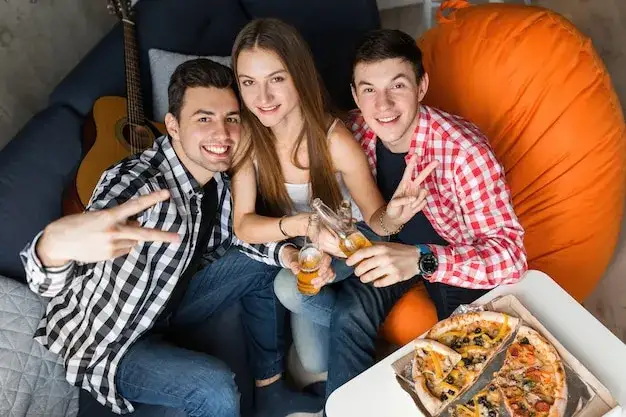 ludzie jedzą pizzę impreza